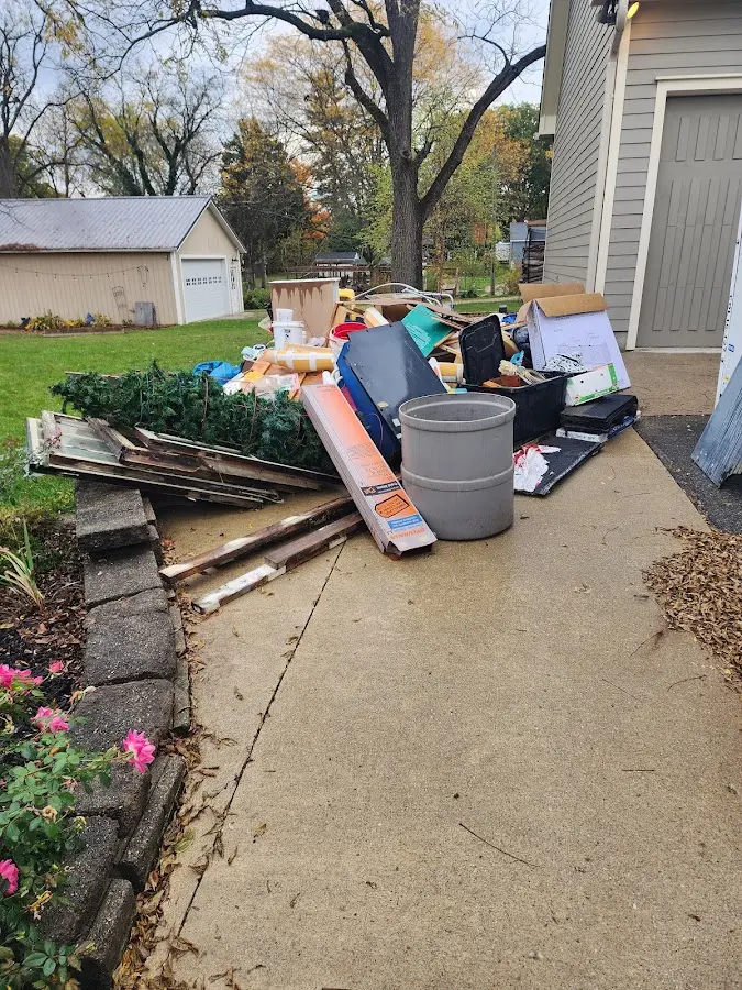 Dumpster being loaded with debris for Estate Cleanout Dumpster Rental in Randolph Town
